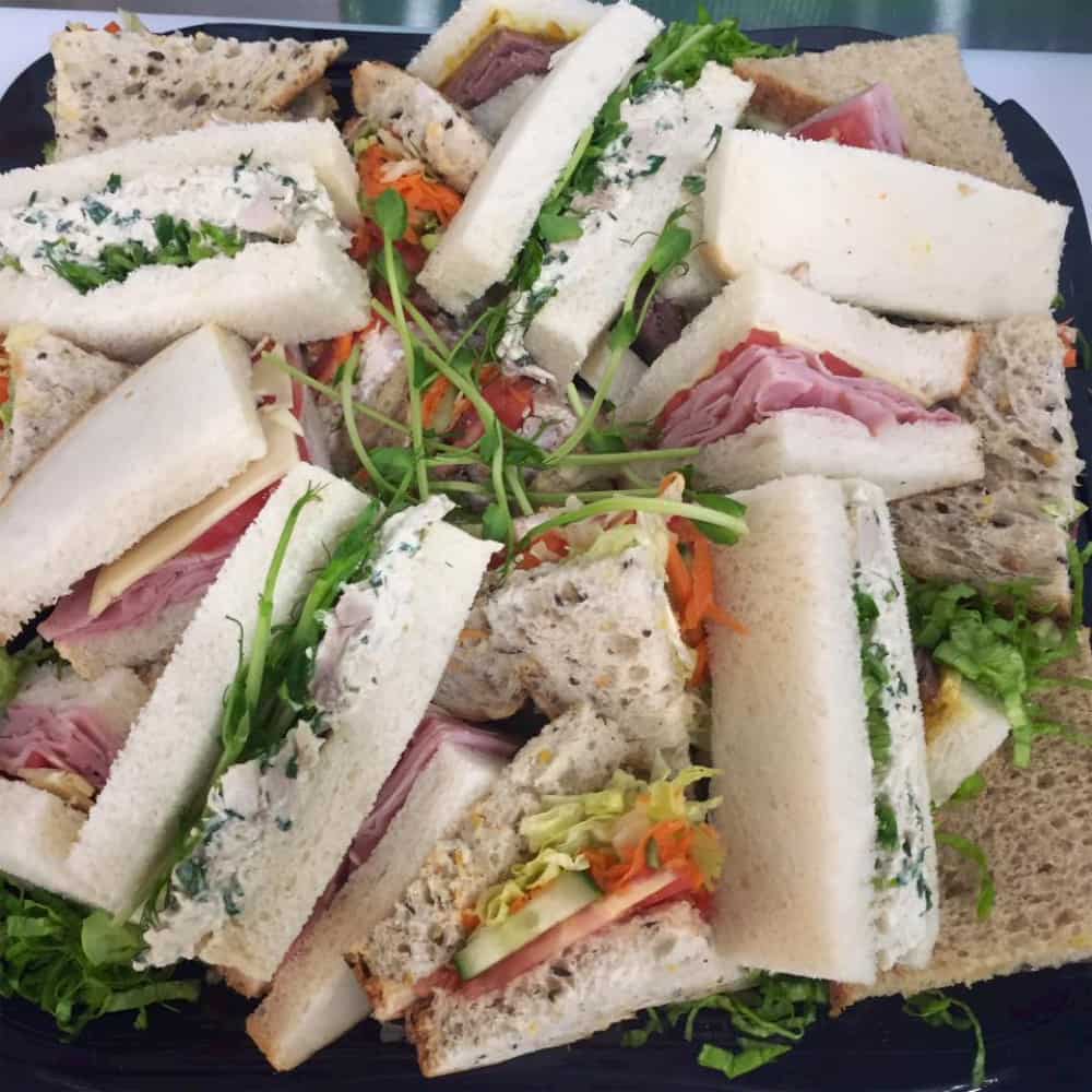 This is a selection of gourmet sandwiches with ham, salad and mixed cheeses.