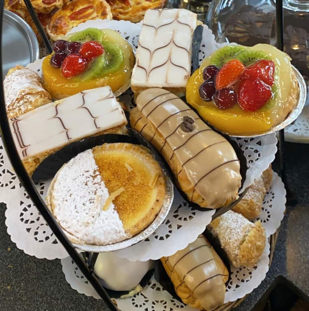 Two plates of Danishes and sweet pastries. 